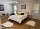 Inviting bedroom with hardwood floors, a cozy bed with throw pillows, and stylish decor at 18211 N Conestoga Dr, Sun City, AZ 85373