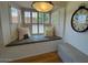 Inviting window seat area with custom shutters, decorative pillows, and a cozy reading nook at 18211 N Conestoga Dr, Sun City, AZ 85373