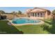 Sparkling private pool surrounded by artificial grass and block fence, creating a serene outdoor oasis at 19412 N 77Th Ave, Glendale, AZ 85308