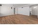Open basement space with wood-look floors, projector, speakers, and easy access to nearby rooms at 19412 N 77Th Ave, Glendale, AZ 85308