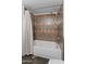 Bathroom featuring shower-tub combination with decorative tile surround at 19412 N 77Th Ave, Glendale, AZ 85308