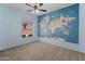 Comfortable bedroom with ceiling fan, world map wallpaper, and natural light from the window at 19412 N 77Th Ave, Glendale, AZ 85308