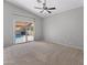 A bedroom with a sliding glass door leads to the outdoor pool at 19412 N 77Th Ave, Glendale, AZ 85308