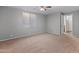 Bright bedroom with plush carpeting, a ceiling fan, and an open doorway at 19412 N 77Th Ave, Glendale, AZ 85308