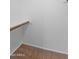A simple closet with wood-bar and one shelf for accessible and organized storage at 19412 N 77Th Ave, Glendale, AZ 85308
