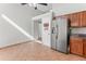 A view of the kitchen with modern appliances, brown cabinets, and tile flooring at 19412 N 77Th Ave, Glendale, AZ 85308