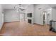 Spacious living room featuring a cozy fireplace, high ceilings, and neutral tile flooring throughout at 19412 N 77Th Ave, Glendale, AZ 85308