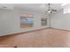 Inviting living room with neutral walls, tile flooring, and lots of natural light from large windows at 19412 N 77Th Ave, Glendale, AZ 85308
