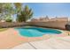 Beautiful backyard pool with mature trees, lush lawn, and concrete patio, ideal for relaxation at 19412 N 77Th Ave, Glendale, AZ 85308
