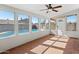 This sun room includes tile flooring, windows, and a door leading to the outdoor pool area at 19412 N 77Th Ave, Glendale, AZ 85308