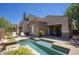 Backyard with beautiful pool, desert landscaping, and patio area perfect for outdoor living at 19475 N Grayhawk Dr # 1046, Scottsdale, AZ 85255