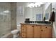 Well-lit bathroom featuring double sinks, modern fixtures, and a separate shower at 19475 N Grayhawk Dr # 1046, Scottsdale, AZ 85255