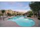Large community pool surrounded by lounge chairs, lush landscaping, and inviting covered seating at 19475 N Grayhawk Dr # 1046, Scottsdale, AZ 85255