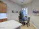 Cozy dining area features modern lighting, a round table, and comfortable seating, perfect for intimate meals at 19475 N Grayhawk Dr # 1046, Scottsdale, AZ 85255