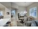 Elegant dining area adjacent to the living room, highlighted by stylish lighting and plantation shutters at 19475 N Grayhawk Dr # 1046, Scottsdale, AZ 85255