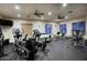 Bright gym equipped with various machines, ceiling fans, and large windows, ready for workouts at 19475 N Grayhawk Dr # 1046, Scottsdale, AZ 85255