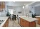 Open kitchen with wooden cabinets, stainless steel appliances, and dining area with bright light at 19475 N Grayhawk Dr # 1046, Scottsdale, AZ 85255