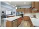 Modern kitchen featuring stainless appliances, wooden cabinets, quartz counters, and backsplash at 19475 N Grayhawk Dr # 1046, Scottsdale, AZ 85255