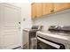 Bright laundry room features an LG washer and dryer and convenient overhead storage cabinets at 19475 N Grayhawk Dr # 1046, Scottsdale, AZ 85255