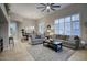 Spacious living room featuring neutral tones, a ceiling fan, and open access to the dining area at 19475 N Grayhawk Dr # 1046, Scottsdale, AZ 85255