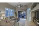 Comfortable living room showcasing large windows, a ceiling fan, and direct access to the outdoor patio at 19475 N Grayhawk Dr # 1046, Scottsdale, AZ 85255