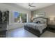 Inviting main bedroom with neutral tones, a ceiling fan, plantation shutters, and large windows at 19475 N Grayhawk Dr # 1046, Scottsdale, AZ 85255