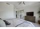 Bright main bedroom with a ceiling fan, sliding doors to the patio, and neutral decor at 19475 N Grayhawk Dr # 1046, Scottsdale, AZ 85255