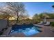 Backyard pool area with a waterfall feature, lounge seating, and serene landscaping at 19475 N Grayhawk Dr # 1046, Scottsdale, AZ 85255