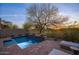 Inviting pool with a tiled water feature and cozy lounge seating offers relaxation at sunset at 19475 N Grayhawk Dr # 1046, Scottsdale, AZ 85255