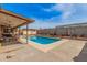 A refreshing backyard pool with a covered patio and surrounding landscaping at 20053 N 15Th Dr, Phoenix, AZ 85027