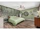 A view of a bedroom with green walls and wood flooring at 20053 N 15Th Dr, Phoenix, AZ 85027