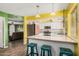 Open kitchen with breakfast bar, stainless steel appliances, and wood floors at 20053 N 15Th Dr, Phoenix, AZ 85027