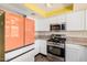 Modern kitchen with stainless steel appliances, sleek cabinetry, and wood floors at 20053 N 15Th Dr, Phoenix, AZ 85027