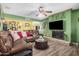 Comfortable living room featuring a fireplace, wood floors and leather seating at 20053 N 15Th Dr, Phoenix, AZ 85027