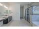 Modern bathroom featuring double sinks, large shower and bathtub with tiled walls at 20258 W Catalina Dr, Buckeye, AZ 85396