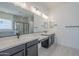 Bright bathroom with a large mirror, dual sinks, and sleek black fixtures at 20258 W Catalina Dr, Buckeye, AZ 85396