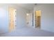 Spacious bedroom with neutral carpet and multiple doorway entrances at 20258 W Catalina Dr, Buckeye, AZ 85396