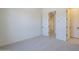 Bright bedroom featuring neutral carpet and two white interior doors at 20258 W Catalina Dr, Buckeye, AZ 85396