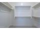 Walk-in closet with neutral paint, shelving, and hanging rods for optimal storage at 20258 W Catalina Dr, Buckeye, AZ 85396