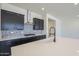 Modern kitchen featuring dark cabinets, mosaic backsplash, stainless steel appliances and large island at 20258 W Catalina Dr, Buckeye, AZ 85396