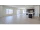 Bright open concept living room and kitchen area with tiled floors and natural light at 20258 W Catalina Dr, Buckeye, AZ 85396