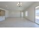 Bright open concept living room area with tiled floors, modern light fixture and natural light at 20258 W Catalina Dr, Buckeye, AZ 85396