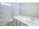 Bright bathroom featuring neutral countertops and a shower-tub combination at 20263 W Catalina Dr, Buckeye, AZ 85396