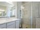 A modern bathroom features a glass shower enclosure with gray tile and a white vanity at 20263 W Catalina Dr, Buckeye, AZ 85396