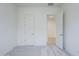 A view of a bedroom featuring an open white door, complemented by soft, neutral carpet at 20263 W Catalina Dr, Buckeye, AZ 85396
