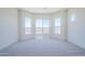 A bright bedroom boasts three windows offering outdoor views, complemented by neutral-colored carpeting at 20263 W Catalina Dr, Buckeye, AZ 85396