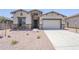 Charming single-Gathering home featuring stone accents, neutral stucco, a two-car garage, and low-maintenance landscaping at 20263 W Catalina Dr, Buckeye, AZ 85396