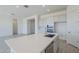 Bright and modern kitchen showcasing a large island, stainless steel appliances, gray cabinets and quartz countertops at 20263 W Catalina Dr, Buckeye, AZ 85396