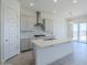 Modern kitchen featuring an island with quartz countertops, stainless steel appliances, marble backsplash and pendant lighting at 20263 W Catalina Dr, Buckeye, AZ 85396