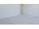 A bright living room featuring neutral carpet and baseboards at 20263 W Catalina Dr, Buckeye, AZ 85396